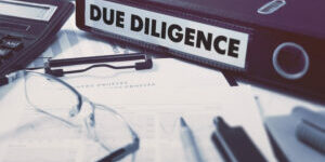 Due Diligence - Ring Binder on Office Desktop with Office Supplies. Business Concept on Blurred Background. Toned Illustration.