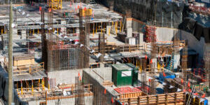 Foundation pit of high-rise building under constraction. Underground parkage construction.